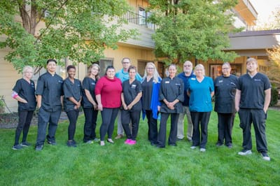 Staff members posing together outside the facility
