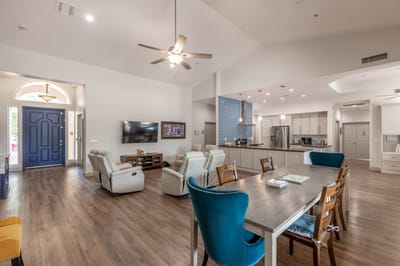 Bright common area with seating and a kitchen