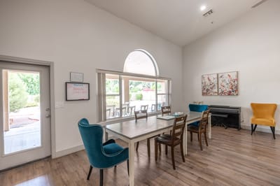 Bright common area with a table and chairs