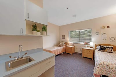 Cozy resident room with beds and furnishings