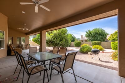 Outdoor patio area with seating and greenery.