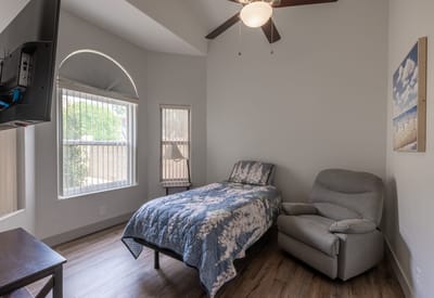 Cozy resident room with a bed and chair