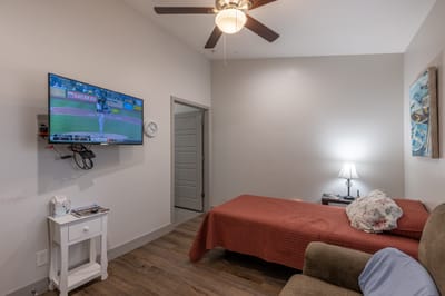 Cozy resident room with a TV and bed