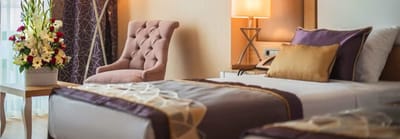 Cozy bedroom with floral decor and elegant furnishings.