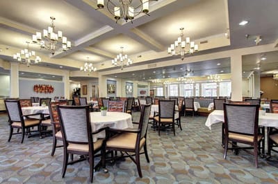 Dining area with tables and chandeliers.