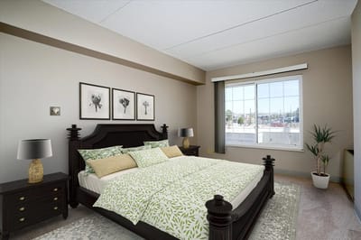 Well-furnished bedroom with decorative accents and a window view.