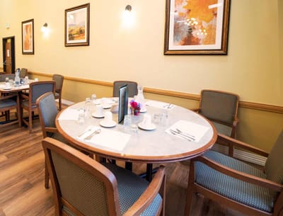 Dining area with a round table set for meals