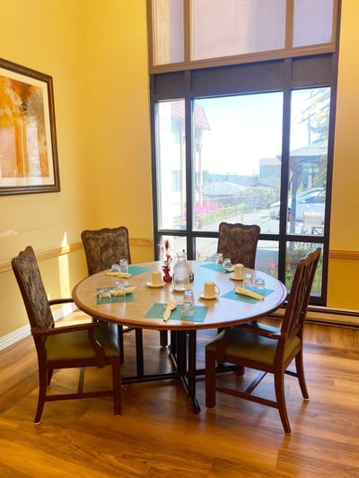 Dining room with a round table set for a meal.