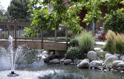 Resident enjoying the outdoor garden area