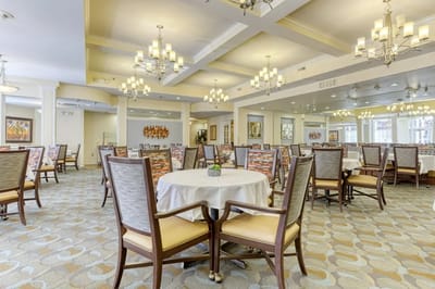 Elegant dining room with tables and chairs.