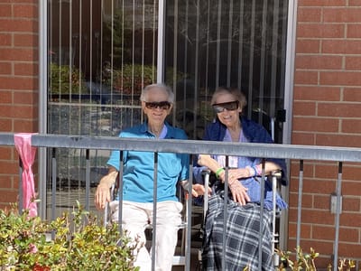 Two residents enjoying the outdoors on a sunny day.