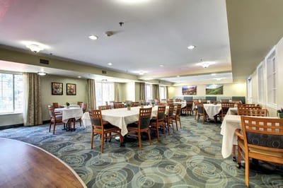 Dining area with tables and chairs set up.