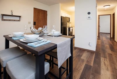 Well-set dining table in a facility dining room.