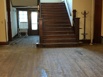 Staircase leading to a well-lit entrance area.