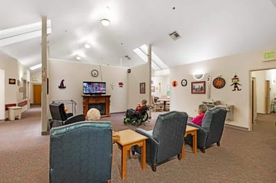 Residents enjoying a common area while watching TV.