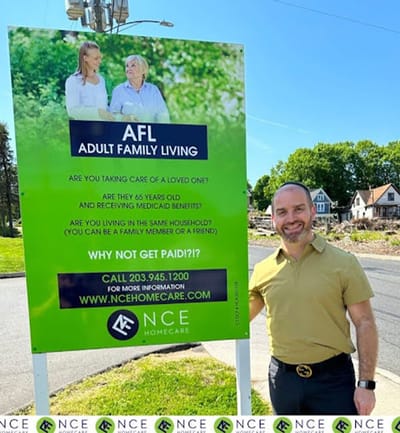 Marketing sign featuring staff and resident interaction.