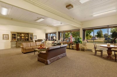 Comfortable common area with seating and windows.