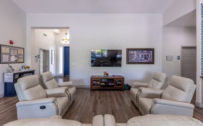 Cozy common area with recliners and television