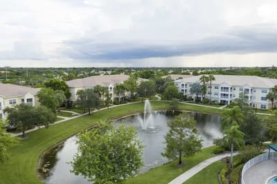 Aerial view of a senior living complex with a pond
