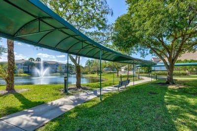 Covered walkway by a pond with fountain