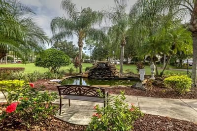 Serene garden area with a pond and bench