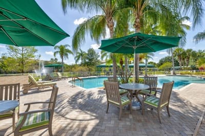 Outdoor pool area with seating and umbrellas