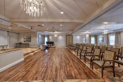 Interior view of an activity room with chairs and stage