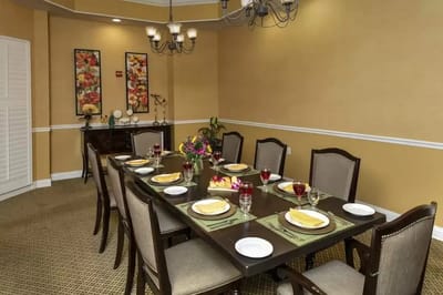 Dining area set with plates and flowers