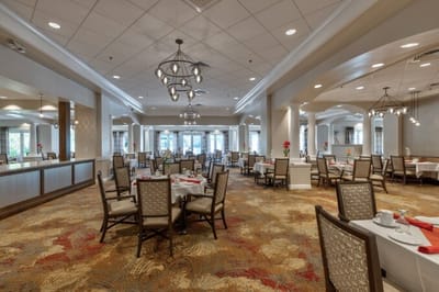 Bright dining room with tables set for meals