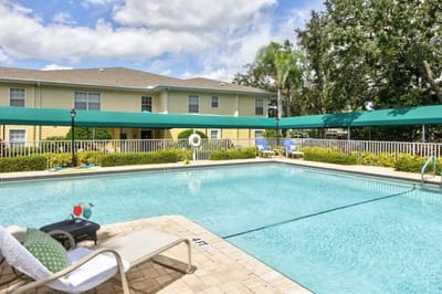 A scenic pool area with lounge chairs and umbrellas