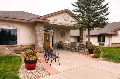 Entrance of a senior living facility with landscaping
