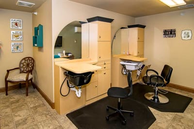 A hair salon area with styling chairs and mirrors