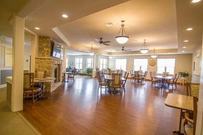 Spacious dining room with wooden floors and large windows
