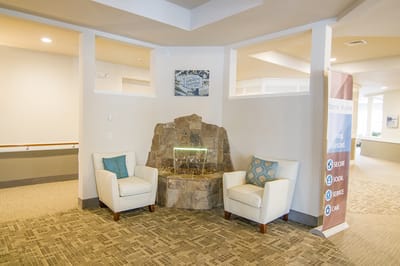 Interior common area with seating and decorative water feature