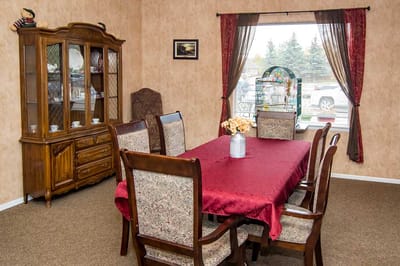 Dining area with a red tablecloth and wooden furniture