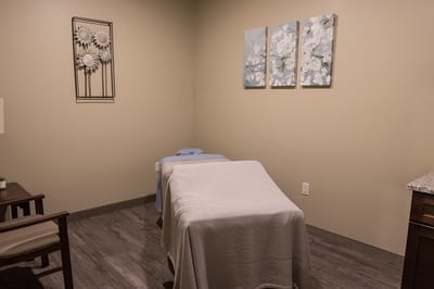 Spa treatment room with calming decor and light colors