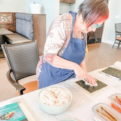 Resident preparing sushi in the activity room