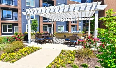 Outdoor seating area with flowers and a pergola