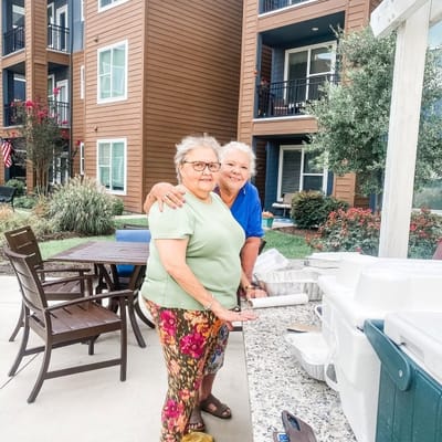 Two residents enjoying an outdoor gathering at the facility