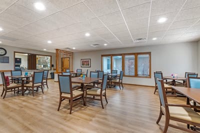 Dining area with tables and chairs in a senior living facility