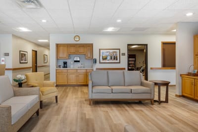 Bright common area with seating and kitchenette