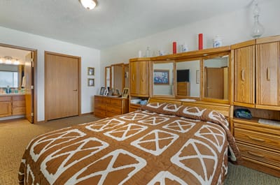 Cozy resident room featuring a bed and wooden furniture