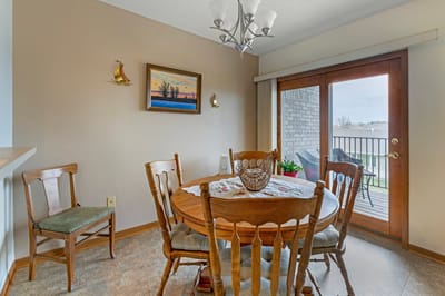 Dining area with a table and chairs overlooking a balcony