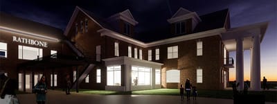 Exterior view of Rathbone Home at dusk with people present