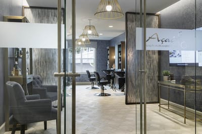 View of a beauty salon interior with chairs and lighting