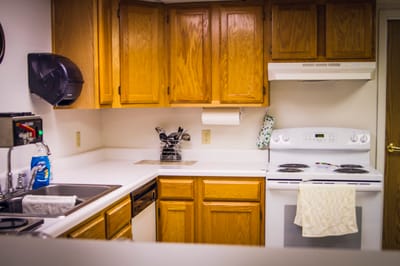 Bright kitchen area with wooden cabinets and appliances