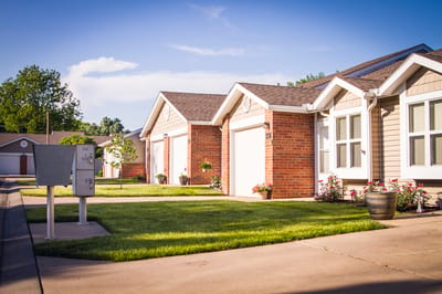 Exterior view of residential units with green lawn