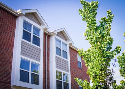 Exterior view of a residential building with tree