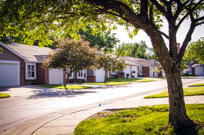 Quiet street lined with residential units in sunny weather