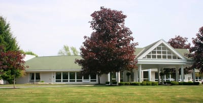 Exterior view of Fallbrook Woods facility with trees